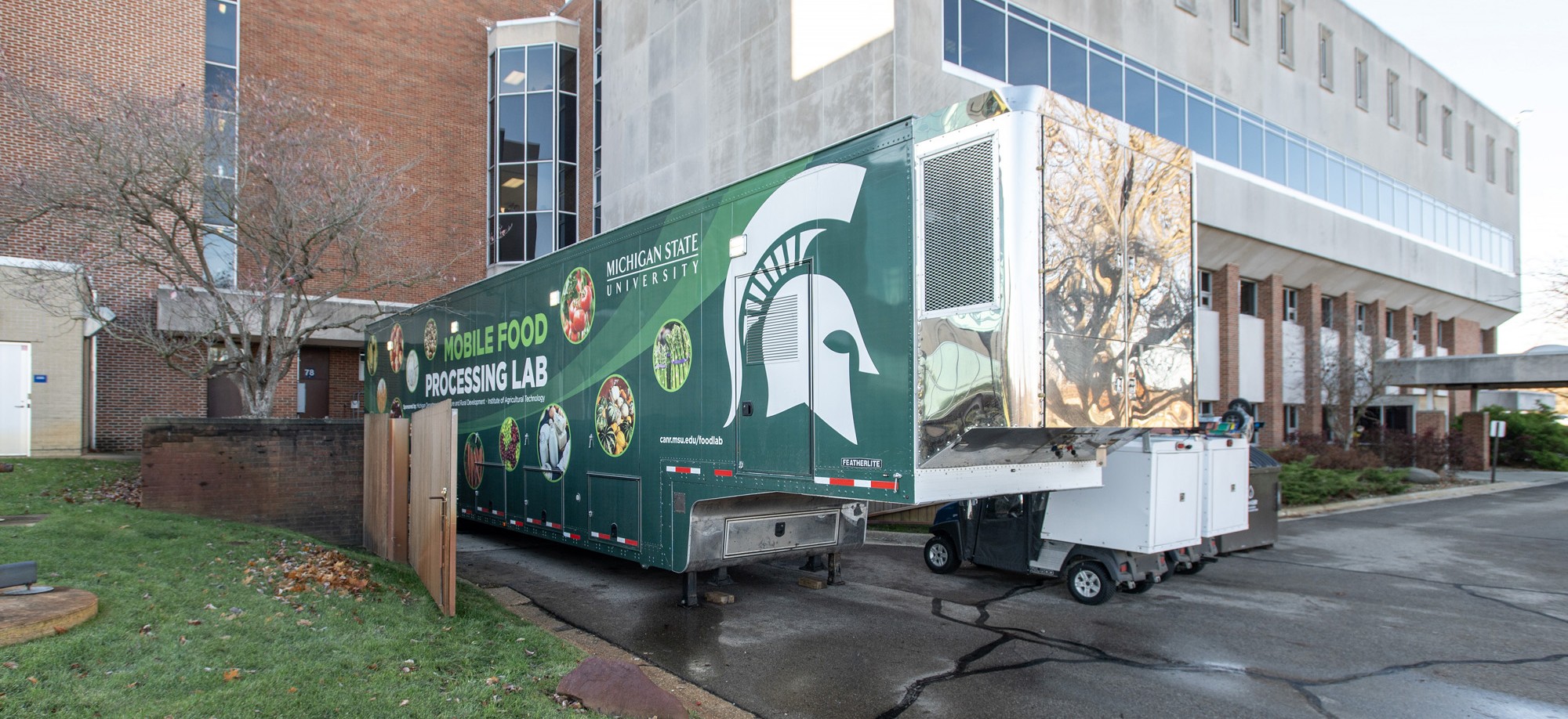 Michigan State University’s mobile food processing lab is parked outside a campus building during a workforce training event.